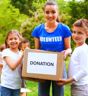 smiling people while holding donation box